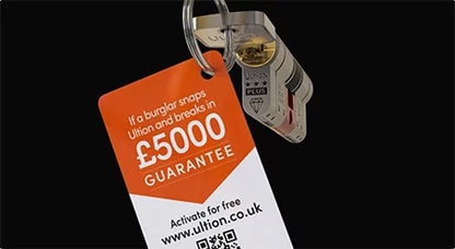Keychain with a security tag featuring a £5000 guarantee on a black background